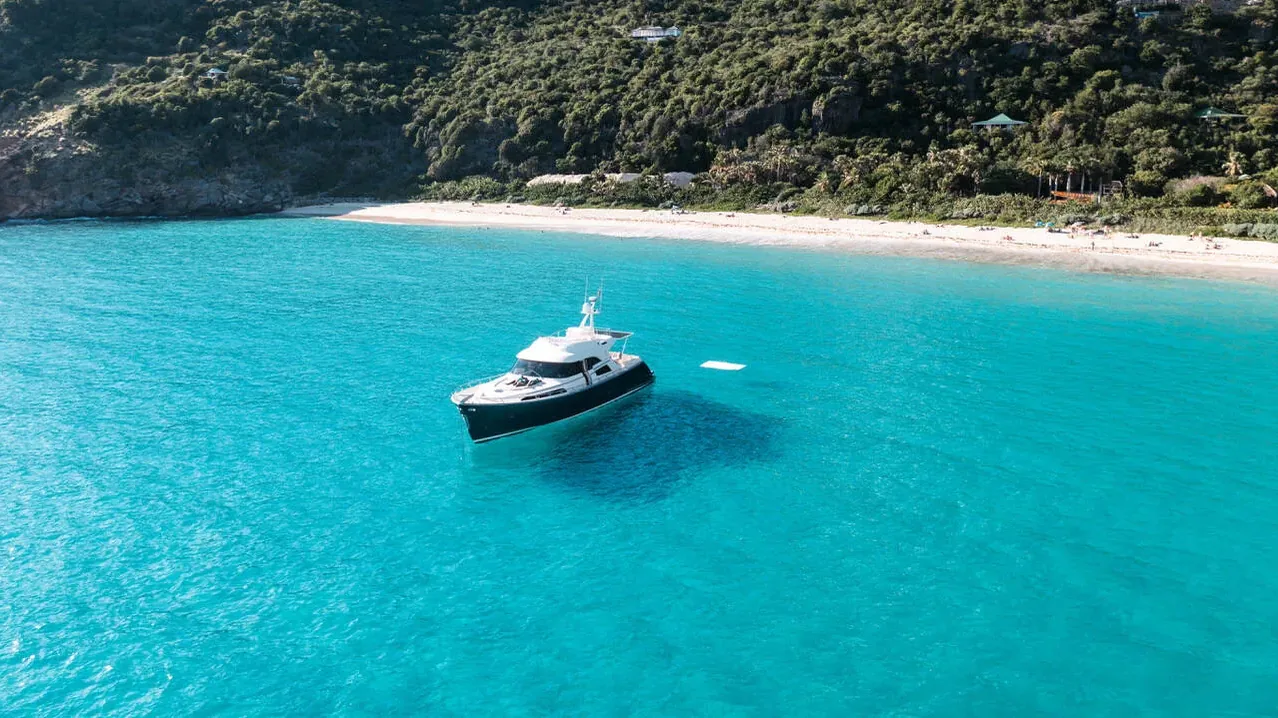 Charter boat at anchor off a white-sand beach, Saint-Barthélemy