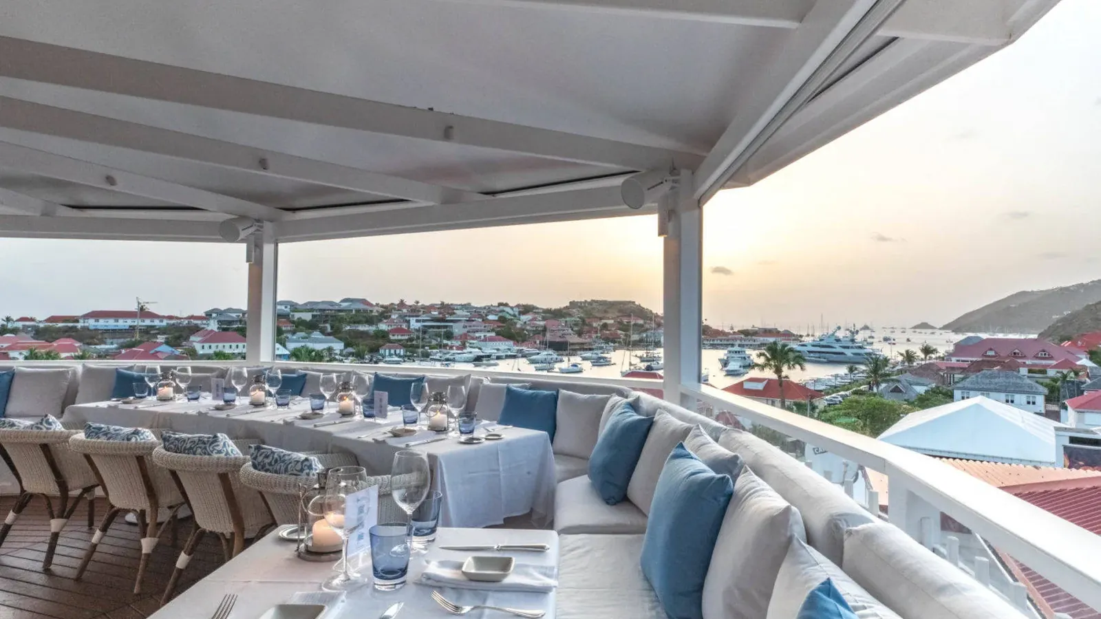Restaurant terrace laid for dinner above Gustavia harbour, Saint-Barthélemy