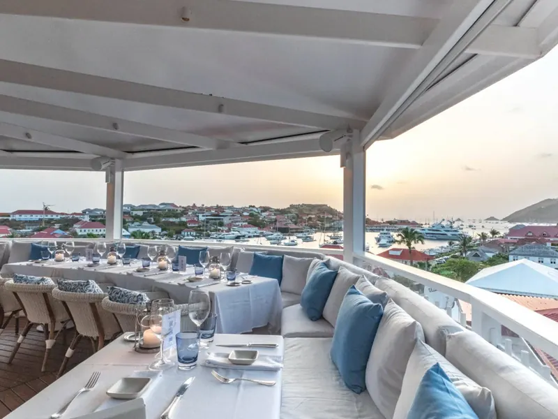 Restaurant terrace laid for dinner above Gustavia harbour, Saint-Barthélemy