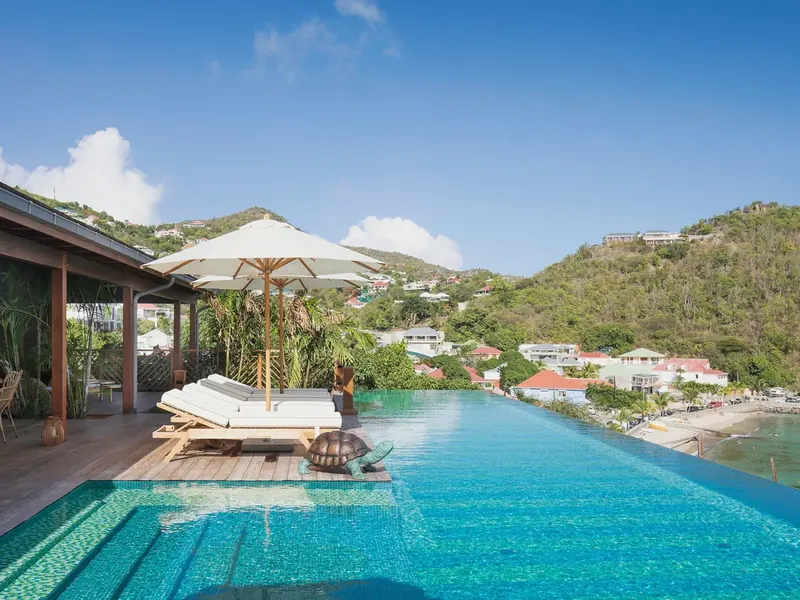 Pool and sun loungers at Villa Nanne, Corossol, Saint-Barthélemy, above the bay
